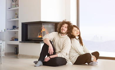 Image showing happy multiethnic couple  in front of fireplace