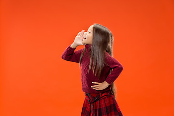 Image showing Isolated on blue young casual teen girl shouting at studio