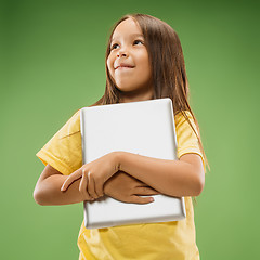 Image showing Teen girl with laptop. Love to computer concept. Attractive female half-length front portrait, trendy green studio backgroud.