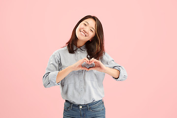 Image showing Portrait of attractive cute girl with bright makeup with kiss isolated over pink background