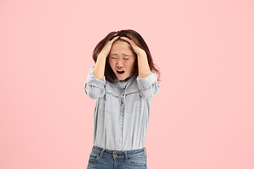 Image showing Beautiful woman looking suprised and bewildered isolated on pink