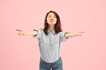 Image showing Portrait of attractive cute girl with bright makeup with kiss isolated over pink background