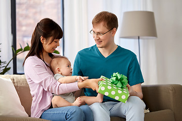 Image showing mother with baby giving birthday present to father