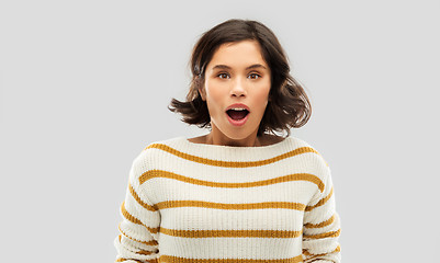 Image showing surprised young woman in striped pullover