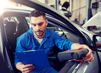 Image showing mechanic man with diagnostic scanner at car shop