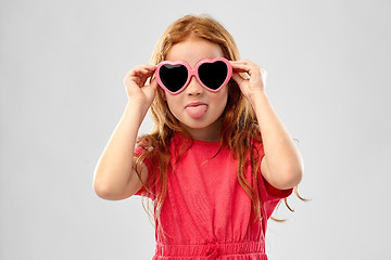 Image showing naughty red haired girl in heart shaped sunglasses