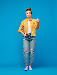 Image showing happy red haired teenage girl showing thumbs up