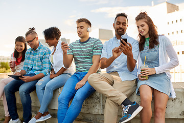 Image showing friends with smartphones and tablet pc in city