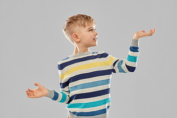 Image showing smiling boy holding something on empty hands