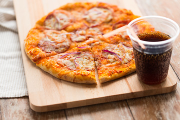 Image showing close up of homemade pizza with cola on table