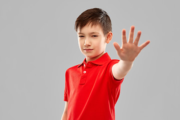 Image showing boy in red t-shirt making stop gesture