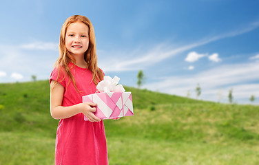 Image showing smiling red haired girl with birthday gift