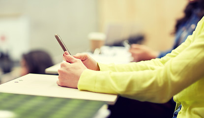 Image showing close up of student with smartphones on lecture