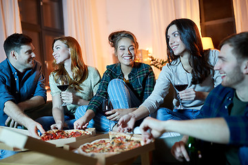 Image showing friends eating pizza and drinking red wine at home