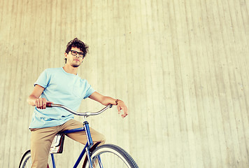 Image showing young hipster man riding fixed gear bike