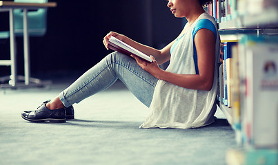 Image showing happy african student girl reading book at library