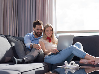 Image showing couple relaxing at  home using laptop computer