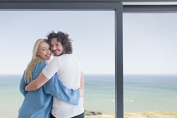 Image showing young couple enjoying morning coffee by the window