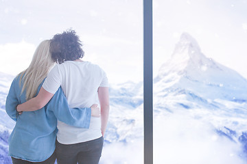 Image showing young couple enjoying morning coffee by the window