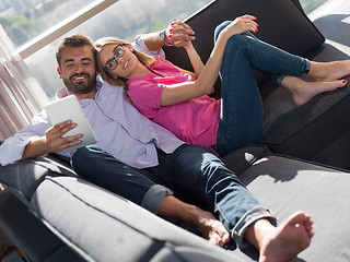 Image showing couple relaxing at  home with tablet computers