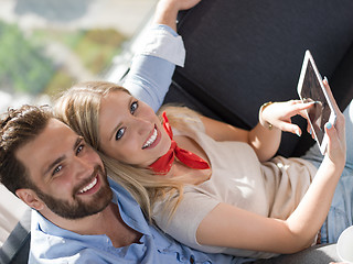 Image showing couple relaxing at  home with tablet computers