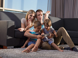 Image showing happy young couple spending time with kids