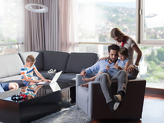 Image showing happy young couple spending time with kids