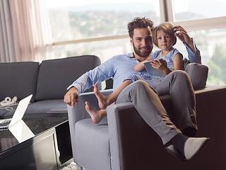 Image showing girl and her handsome father using a digital tablet