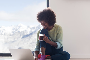 Image showing black woman in the living room on the floor