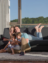 Image showing happy young couple spending time with kids