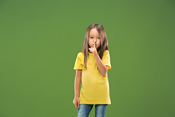 Image showing The young teen girl whispering a secret behind her hand