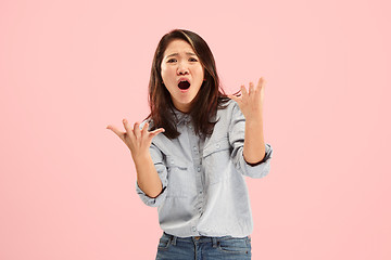 Image showing Beautiful female half-length portrait isolated on pink studio backgroud. The young emotional surprised woman