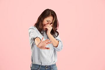 Image showing Let me think. Doubtful pensive woman with thoughtful expression making choice against pink background