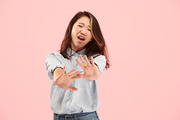 Image showing Let me think. Doubtful pensive woman with thoughtful expression making choice against pink background