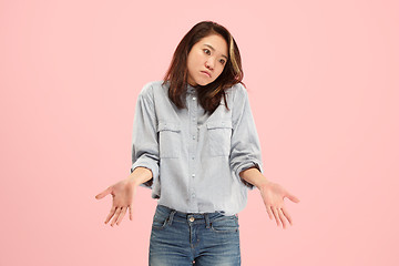 Image showing Beautiful woman looking suprised and bewildered isolated on pink