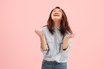 Image showing Beautiful female half-length portrait isolated on pink studio backgroud. The young emotional surprised woman