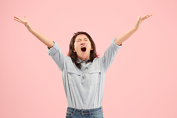 Image showing The young emotional angry woman screaming on studio background