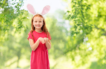 Image showing happy red haired girl wearing easter bunny ears