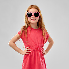 Image showing smiling red haired girl in heart shaped sunglasses