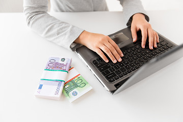 Image showing close up of businesswoman with laptop and money