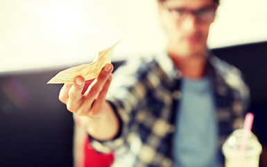 Image showing happy man with cash money paying at cafe