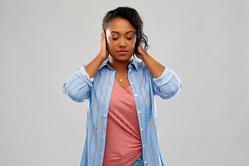 Image showing african american woman closing ears by hands