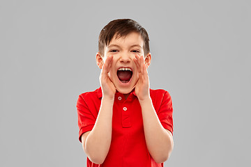 Image showing angry little boy in red polo t-shirt screaming