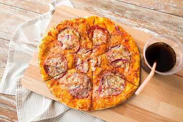 Image showing close up of homemade pizza with cola on table