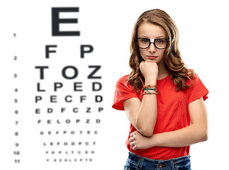 Image showing teenage girl in glasses over eye test chart