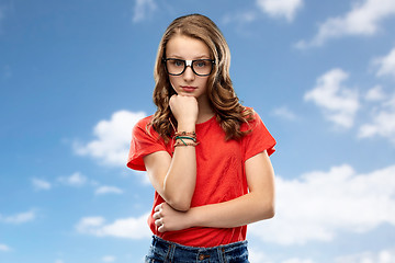 Image showing student girl in glasses thinking over sky