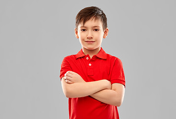 Image showing smiling boy in red t-shirt with crossed arms