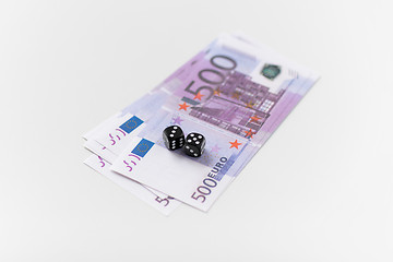 Image showing close up of black dice and euro money