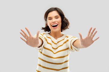 Image showing happy woman showing ten fingers of two hands