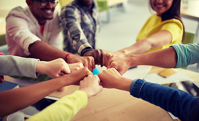 Image showing close up of international students hands fist bump